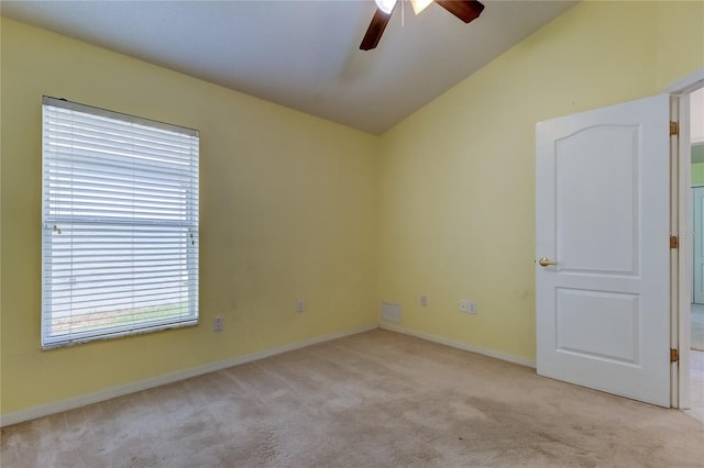 carpeted empty room with vaulted ceiling and ceiling fan