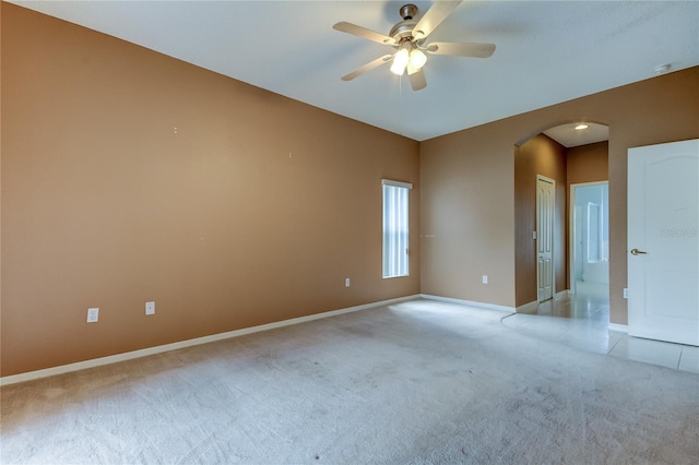 spare room featuring light carpet and ceiling fan