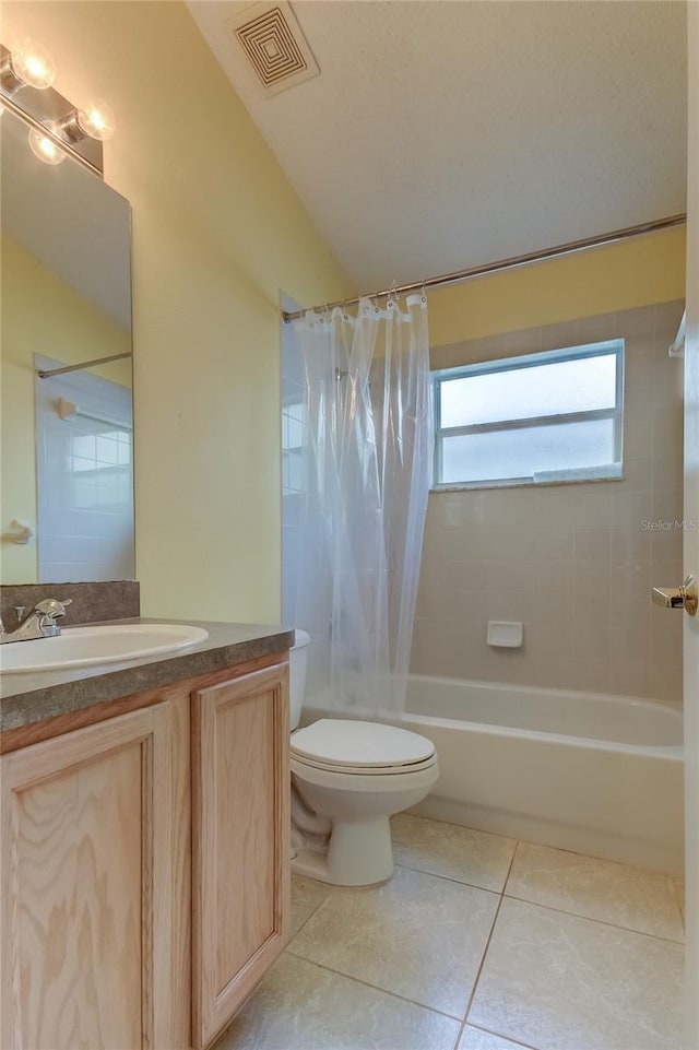 full bathroom with shower / tub combo, tile patterned floors, vanity, and toilet