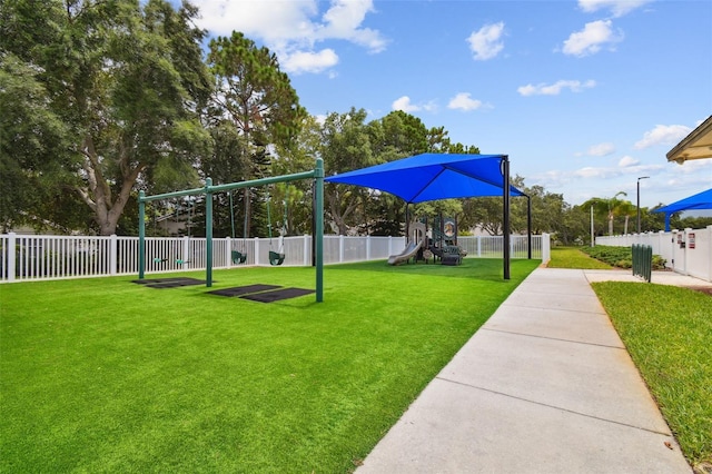 view of property's community featuring a lawn and a playground