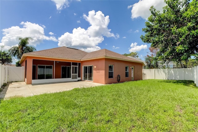 rear view of property featuring a patio area and a lawn