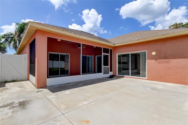 back of house with ceiling fan and a patio