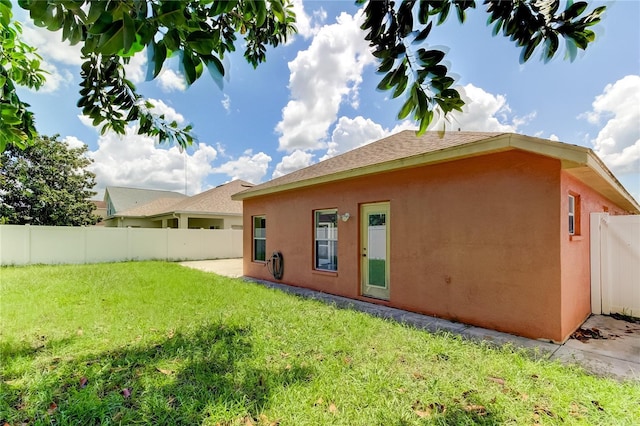 rear view of house with a yard