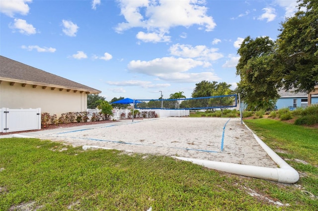 view of community featuring volleyball court and a lawn