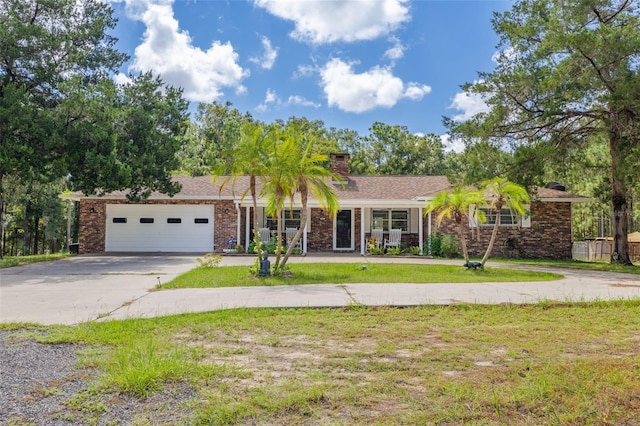 ranch-style house featuring a garage and a front yard