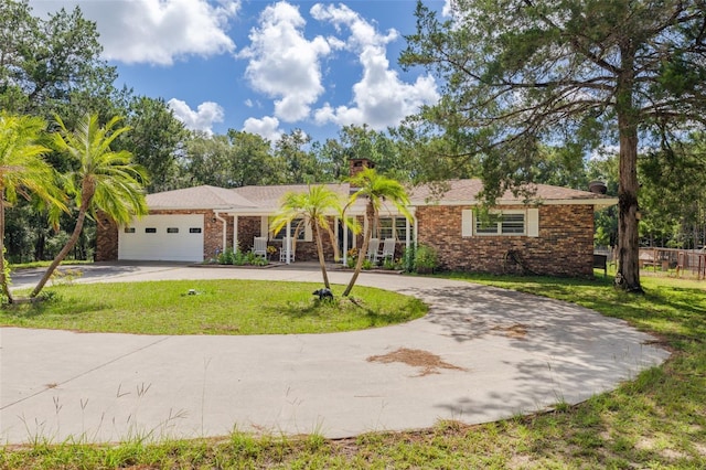 single story home with a front yard and a garage