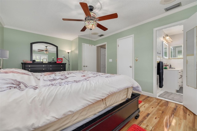 bedroom featuring a textured ceiling, light hardwood / wood-style flooring, ceiling fan, and ornamental molding