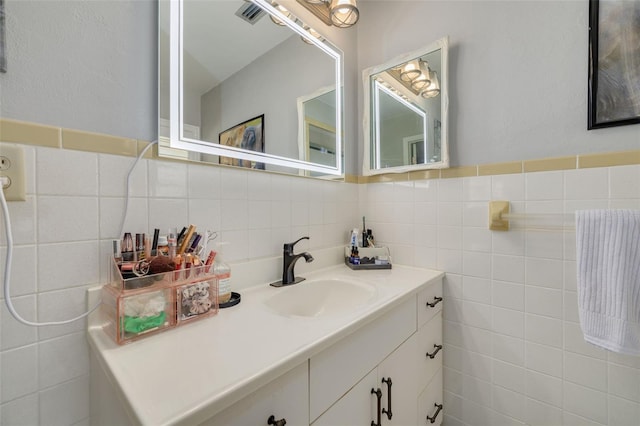 bathroom with vanity, tile walls, and decorative backsplash