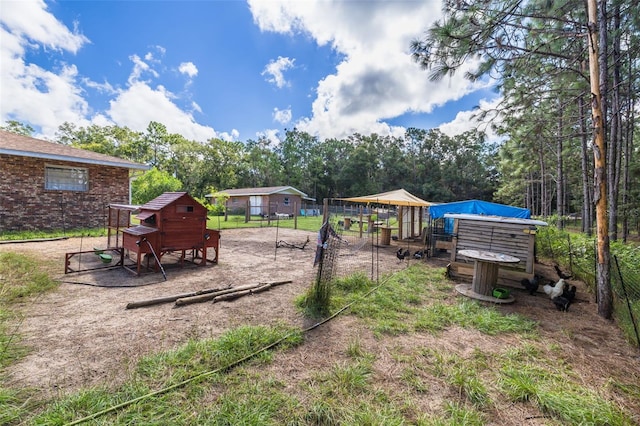 view of yard featuring a playground and an outdoor structure