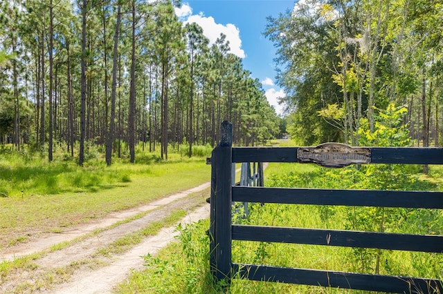 view of gate with a yard