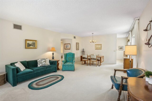 living room with a textured ceiling, carpet, and an inviting chandelier