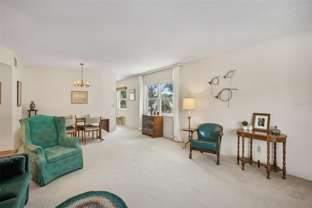 living room featuring a textured ceiling, carpet, and a chandelier