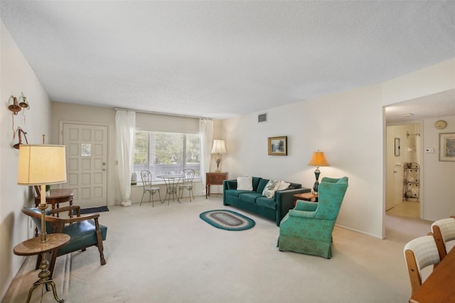 living room featuring light carpet and a textured ceiling