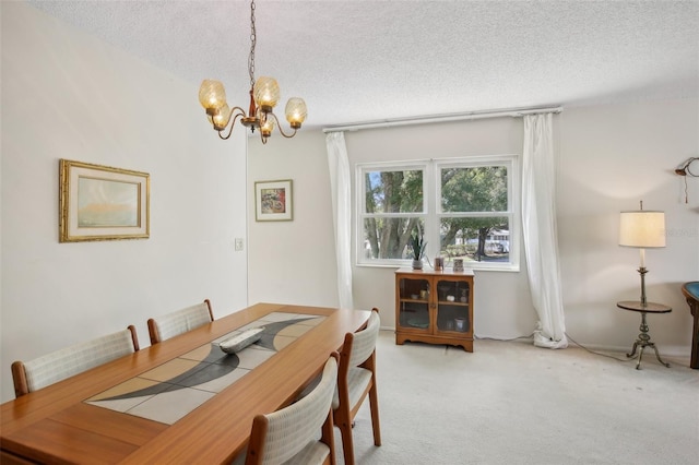 carpeted dining area with a notable chandelier and a textured ceiling