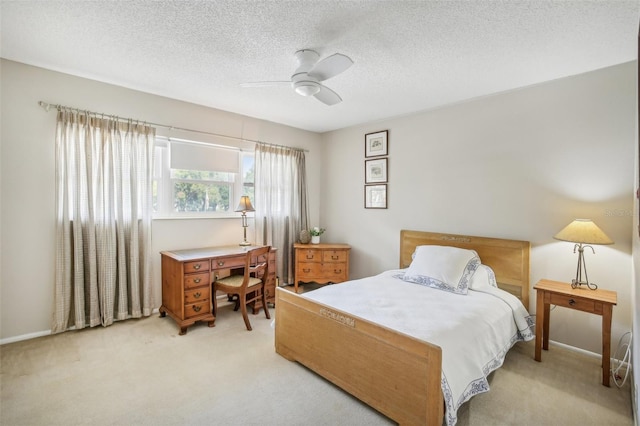 bedroom featuring light carpet, a textured ceiling, and ceiling fan