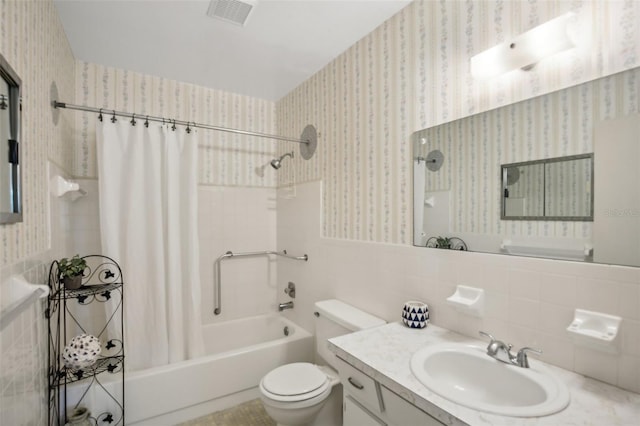 full bathroom featuring shower / bath combo, toilet, tile walls, tasteful backsplash, and vanity