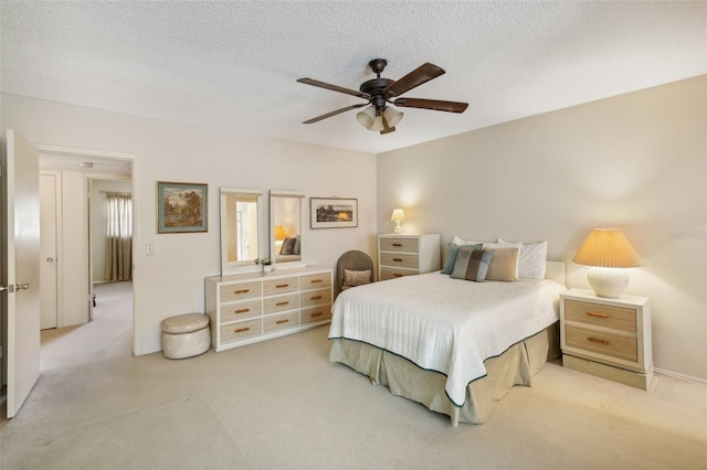 carpeted bedroom with a textured ceiling and ceiling fan