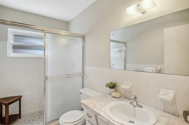 bathroom featuring toilet, an enclosed shower, vanity, decorative backsplash, and tile walls