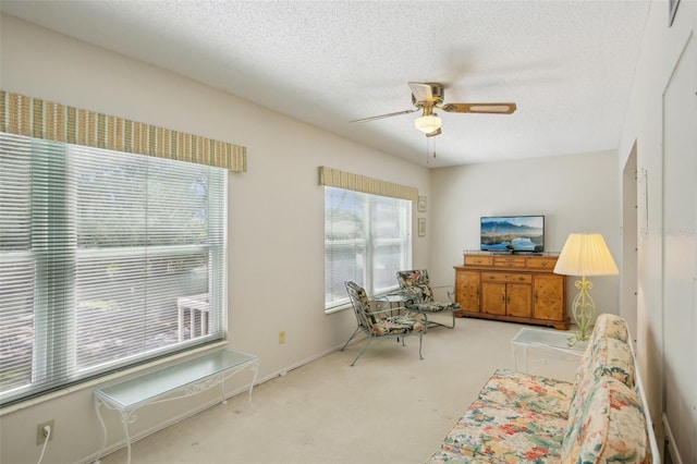 interior space featuring a textured ceiling, carpet flooring, and ceiling fan