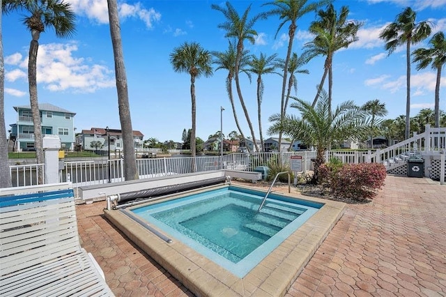 view of swimming pool with a community hot tub