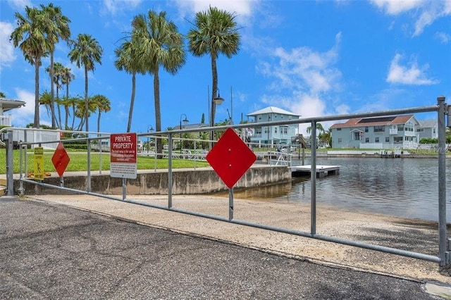 view of home's community featuring a water view and a boat dock