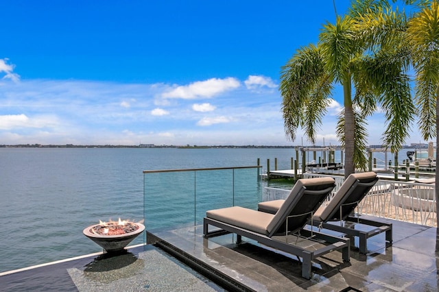 dock area with a water view and an outdoor fire pit