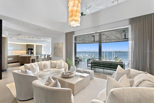 living room with floor to ceiling windows and a water view