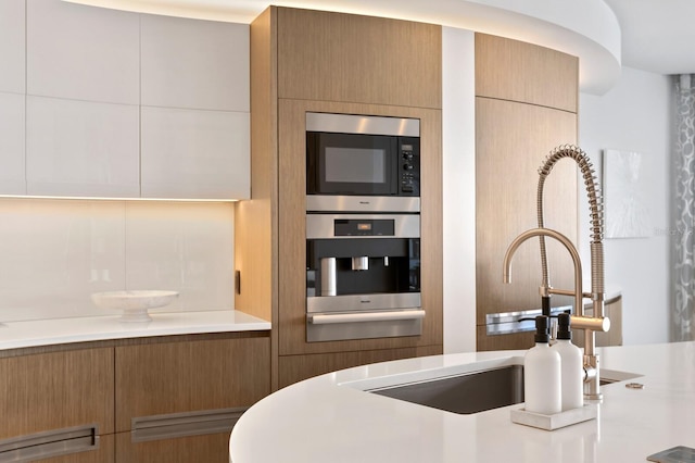 kitchen featuring stainless steel appliances and tasteful backsplash