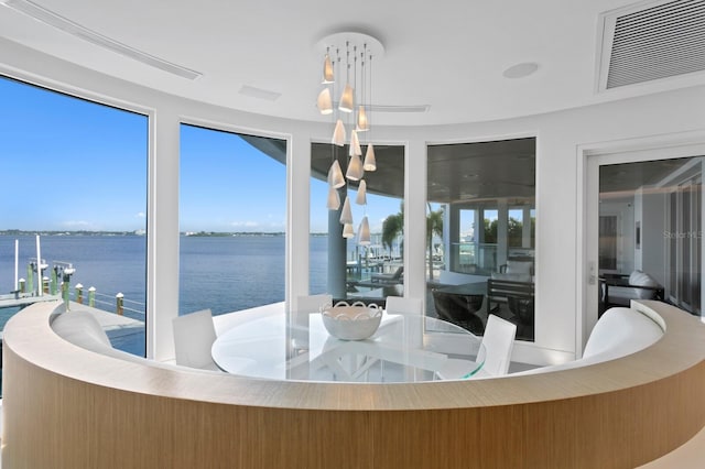 sunroom featuring a water view