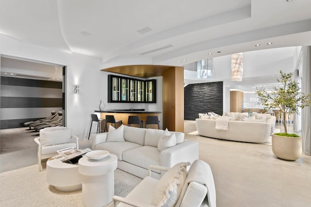 living room with indoor bar and light colored carpet