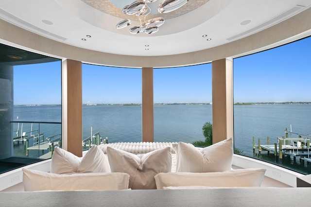 interior space with a notable chandelier and a water view