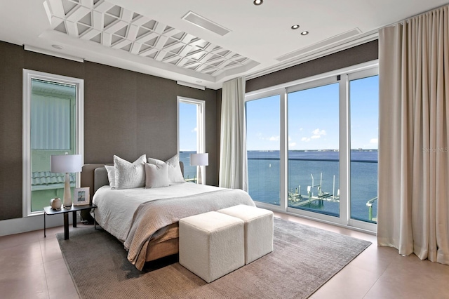 bedroom with a water view and access to exterior