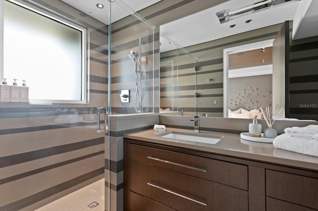 bathroom featuring an enclosed shower and vanity