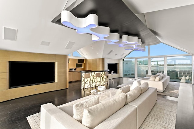 living room with floor to ceiling windows, vaulted ceiling, and hardwood / wood-style flooring