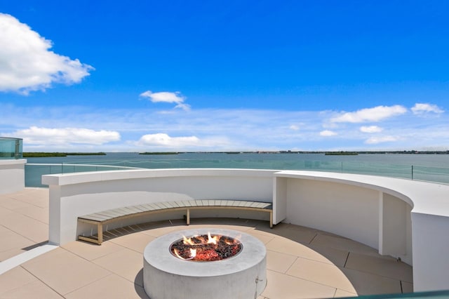 view of patio / terrace with a water view and an outdoor fire pit