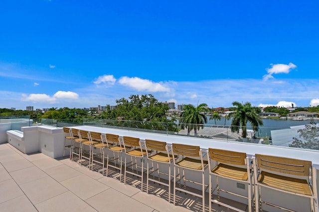 view of patio / terrace featuring exterior bar and a water view