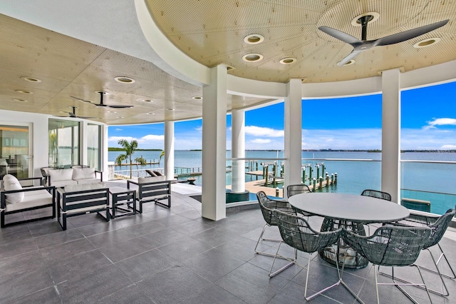 sunroom featuring a water view and a healthy amount of sunlight