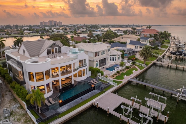 aerial view at dusk with a water view