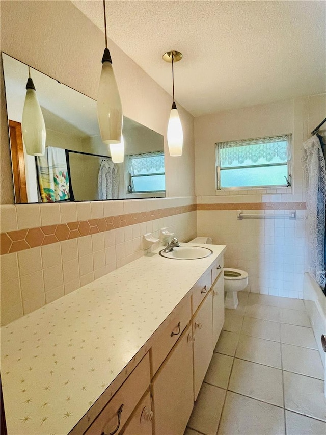 full bathroom with shower / tub combo, a textured ceiling, toilet, tile walls, and vanity