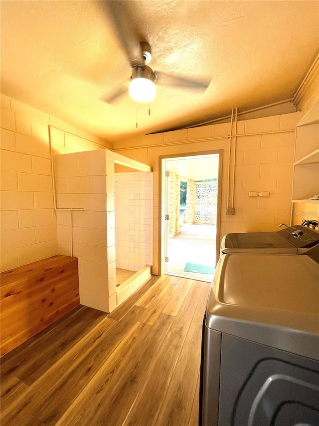 clothes washing area featuring a textured ceiling, wood-type flooring, and ceiling fan