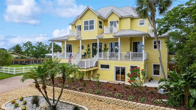 view of front of house featuring a balcony and covered porch