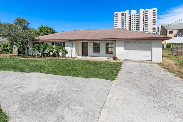 view of front of property with a front yard and a garage