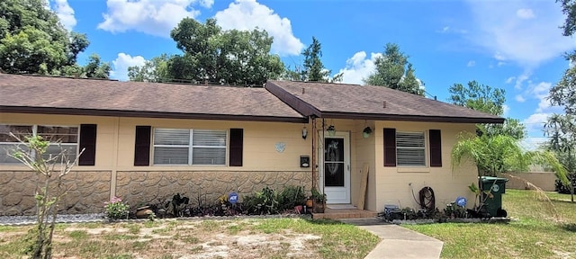 ranch-style home with a front yard