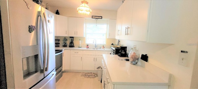 kitchen with decorative light fixtures, stainless steel fridge with ice dispenser, electric stove, sink, and white cabinets