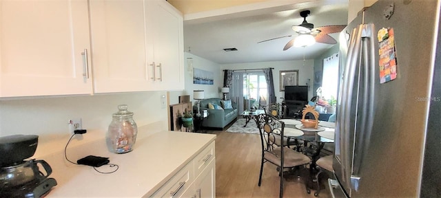 kitchen with light hardwood / wood-style floors, ceiling fan, and white cabinetry