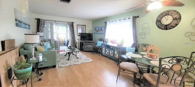 living room with ceiling fan and light wood-type flooring