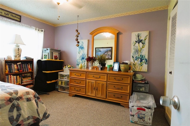 carpeted bedroom featuring a textured ceiling, a closet, and ceiling fan