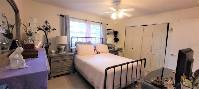 carpeted bedroom with a closet and ceiling fan