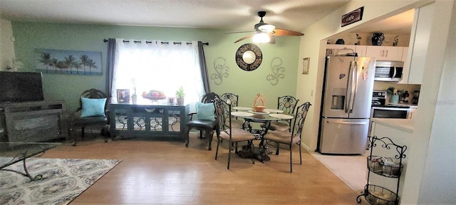 dining room featuring a textured ceiling, ceiling fan, and light hardwood / wood-style flooring