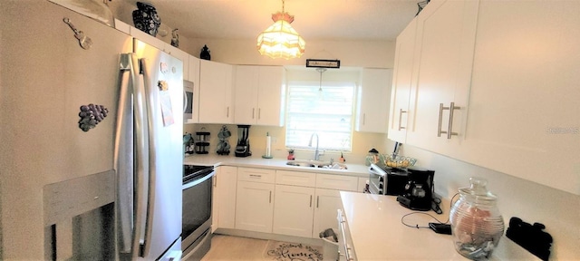 kitchen with pendant lighting, range with electric cooktop, white cabinetry, and sink